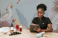 Wellness center, black staff woman using tablet