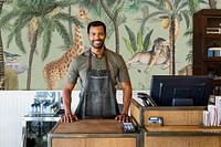 Cafe small business owner smiling at the counter