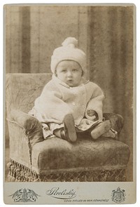 Portrait of a child in a white coat