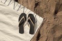 Black sandals mockup psd on beach towel aerial view