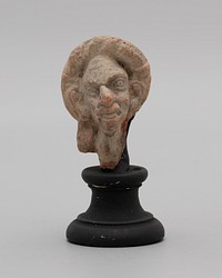 Head of a Grotesque Wearing Wreath by Ancient Greek