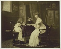 Woman and Child Playing Dominoes at Table by Unknown