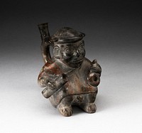 Handle Spout Vessel in the Form of a Figure Holding Corn Popper and Rolled Mat by Moche