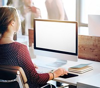 Woman using a desktop computer with an empty screen