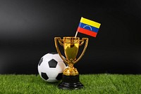 Golden trophy and football ball with flag of Venezuela 