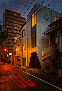 Night Street, Ikebukuro, Toshima, Tokyo, JapanA wet street at night, Higashi-Ikebukuro, Toshima City, Tokyo, Japan. The innovative architecture of low-rise buildings shows their magic.