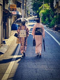 Women Wearing Kimonos, Tokyo, JapanJapanese women wearing traditional garments (kimono) walking along a back street in Nezu, Bunkyo City, Tokyo, Japan.