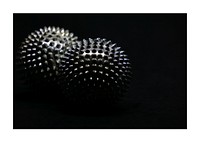 Spiked metallic balls, dark aesthetic.