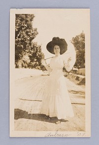 Untitled (Woman in Dress with Parasol Standing on Road)