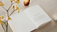 Opened book mockup on a wooden table