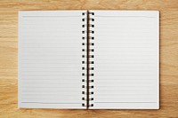 White ruled notebook mockup on a wooden table