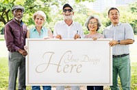 Group of diverse seniors showing a poster mockup in a garden