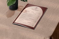 Vintage restaurant menu mockup psd on a table