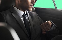 CEO in a back seat checking a wristwatch