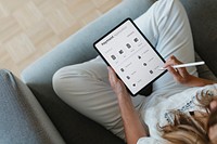 Woman using a stylus with a digital tablet mockup during coronavirus quarantine at home