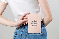 Woman keeping a flyer mockup in her pants pocket