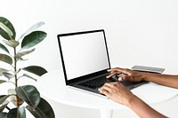 Laptop screen mockup psd on a white table