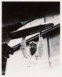 Untitled (Female Pilot Grabbing Propeller)