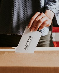 American casting her vote to a ballot box mockup