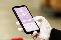 Woman wearing a latex glove while using cellphone to prevent coronavirus contamination mockup screen
