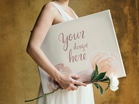 Girl with a white paeonia snowboard flower and a mockup canvas