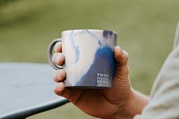 Mug mockup psd being hold by a person