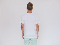 Back side of man wearing a white shirt and mint jeans.