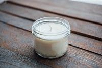 Homemade soy candle, wooden table.