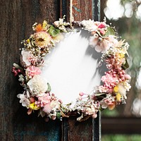Floral wreath hanging on the wooden windowsill