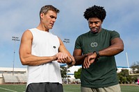 Sports top mockup psd on athlete and coach discussing fitness tracker and performance