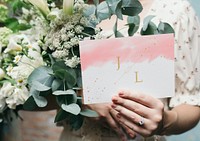 Woman with a wedding invitation card mockup