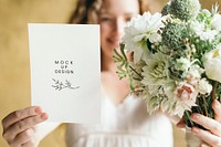 Woman holding a bouquet of white flowers with a card mockup