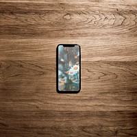 Mobile phone on wooden table, flat lay