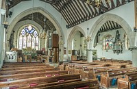 CHURCH OF ST BARTHOLOMEW, THE GREEN OTFORD, KENTNave C11. Tower late C12 in origin. Chancel rebuilt in the C14. S aisle and S chapel early C16. Probably C16 N vestry. W porch of 1637. Church restored and the S arcade rebuilt in 1863 to designs by G E Street. Further restoration in the C20. MATERIALS Flint and stone rubble. Some brick in the tower, which is rendered. Timber W porch. Tiled roofs and shingled spire. PLAN Nave with S aisle. W tower with W porch. Chancel with N vestry and S chapel. EXTERIOR A small, low church with a massive, squat W tower. The tower, which is rendered, is unbuttressed and undivided externally, and has an embattled parapet and a low broach spire. There are tiny, narrow lights in the lower part of the tower. The W porch is dated 1637 and has a pair of panelled outer doors. The porch walls have close set, heavy framing with an open colonnade of chunky, turned baluster shafts above, and there is an openwork pendant in the gable. The N and W walls of the nave are C11, possibly pre-Conquest, and retain early quoins; the buttresses are of 1863. The two N windows are C14, and are of two lights in two different patterns. The chancel is also C14, and has an excellent, and very large, E window of five lights, renewed c.1854, with Decorated tracery and a blocked N window similar to one in the nave. C16 NE vestry at right angles to the chancel with Tudor arched widows and an inserted N door. The S aisle and S chapel have C16 windows with cusped lights under depressed heads with hood moulds, and there is a C16 S door in the aisle, also with a depressed head and hood mould. INTERIOR The three-bay S arcade, which replaces a timber arcade, of 1863 by G E Street, in a C13 style with round piers with moulded capitals and arches of two, chamfered orders. Street also rebuilt the arch to the S chapel and replaced the chancel arch, which is wide and has continuous chamfers. The entrance to the W tower is of door, rather than arch, proportions, and is closed by a door. Probably of the late C12, it is pointed and has two orders towards the nave. The NE vestry has an internal recess that has been identified as a wafer oven for baking communion wafers. The chancel is dominated by the very large monument to Charles Polhill, d.1755, and it also has an excellent C16 Easter Sepulchre tomb in the N wall. PRINCIPAL FIXTURES The monuments are particularly notable. Excellent early C16 Easter Sepulchre-style tomb in the chancel N wall, with a damaged panelled tomb chest and above it a recess with panelled vaulting and a canopy with a brattished cornice. Also in the chancel a group of monuments to members of the Polhill family, including David Polhill, d.1754, by Cheere, a fine bust on a scrolly pedestal with an obelisk behind. Charles Polhill, d. 1755, very large monument, also by Cheere, with a full length standing figure in a toga leaning on an urn and below him, two reading female figures. Also Charles Polhill, d. 1805, by J Bacon, Jnr, a hanging monument with a portrait profile and a willow tree over an urn. Good collection of hatchments. Polygonal font with good C17 font cover. Glass: two small C17 panels in the E window, including the arms of Lennard, and two S aisle windows by Hardman c.1868. Mid C19 nave benches, low with shaped ends and doors, probably c.1845. HISTORY There was Bronze and Iron age settlement in Otford, and Roman remains have also been found. The Archbishops of Canterbury held Otford from as early as the late C9, and the archiepiscopal palace there was rebuilt by Archbishop Warnham in the early C16 in magnificent style, but it is unclear if this was in any way related to the rebuilding of the S aisle and chapel of the church at much the same time. Otford church was a chapel of nearby Shoreham, and the earliest fabric in the church is the C11 N wall. The tower was probably added in the late C12. The chancel was rebuilt in the C14 and the nave provided with new windows. The S aisle and S chapel are early C16, and were referred to as 'the newe ile' in a will of 1532. The Easter Sepulchre tomb in the chancel may be connected to the rebuilding work. The church is said to have been damaged by fire in the mid C17, and the timber arcade replaced by Street was apparently installed after the fire, presumably replacing a medieval arcade. The tower is unusually short, and photographs of it with some of the render removed show that the SW corner, at least, is brick, and it is possible that this is a C17 repair. The low door to the tower may also be a C17 reworking using older materials. There was some refurnishing and repair c.1845, when the E window was renewed; the nave seating is probably also of this date. The church was extensively restored in 1863 to designs by G E Street (1824-81), who was a leader of the Gothic Revival, including the replacement of the nave and chancel arcades and of the chancel arch. There were further repairs in the C20.