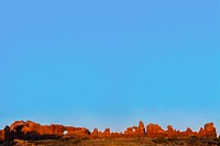 Sandstone arches border sky background