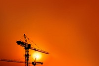 Construction crane, orange background