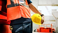 Man holding safety helmet, construction PPE