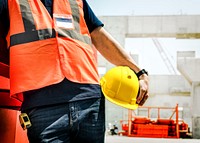 Man holding safety helmet, construction PPE