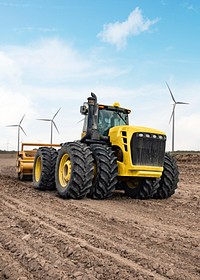 Tractor near wind farm