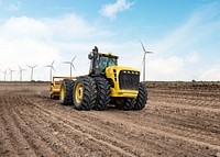 Tractor near wind farm