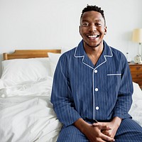 Black man in pajamas smiling