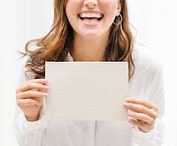 Cheerful woman showing a beige card mockup