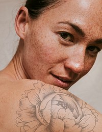 Flower tattoo on woman's shoulder