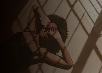 Woman lying on the floor, window shadow aesthetic photo