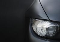 Silver car's headlight closeup background