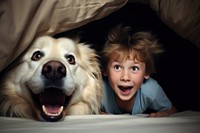 Golden Retriever & kid under blanket