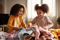 Girls folding clothes together