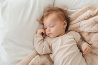 Peaceful sleeping baby on bed