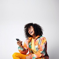 Woman using phone, sitting on a floor