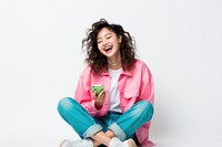 Asian woman using phone, sitting on a floor